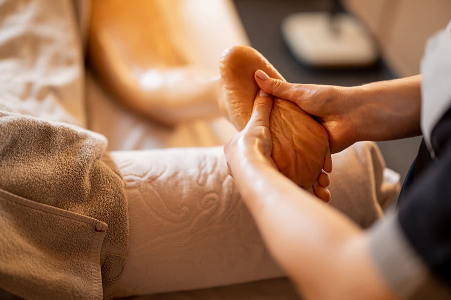 Woman receiving massage on her legs Reflexology 1